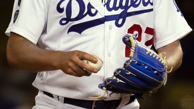 Jun 12, 2021; Los Angeles, California, USA; Los Angeles Dodgers starting pitcher Trevor Bauer grips the ball before throwing a pitch against the Texas Rangers in the seventh inning at Dodger Stadium.